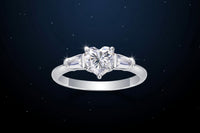 moissanite ring with heart-shaped center stone on a starry night background